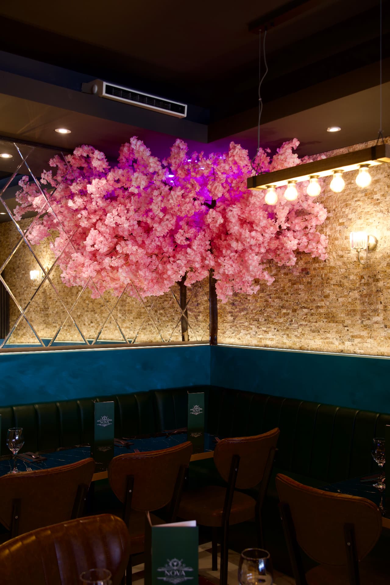 Nova's dining room with its pink blossom tree and intimate tables