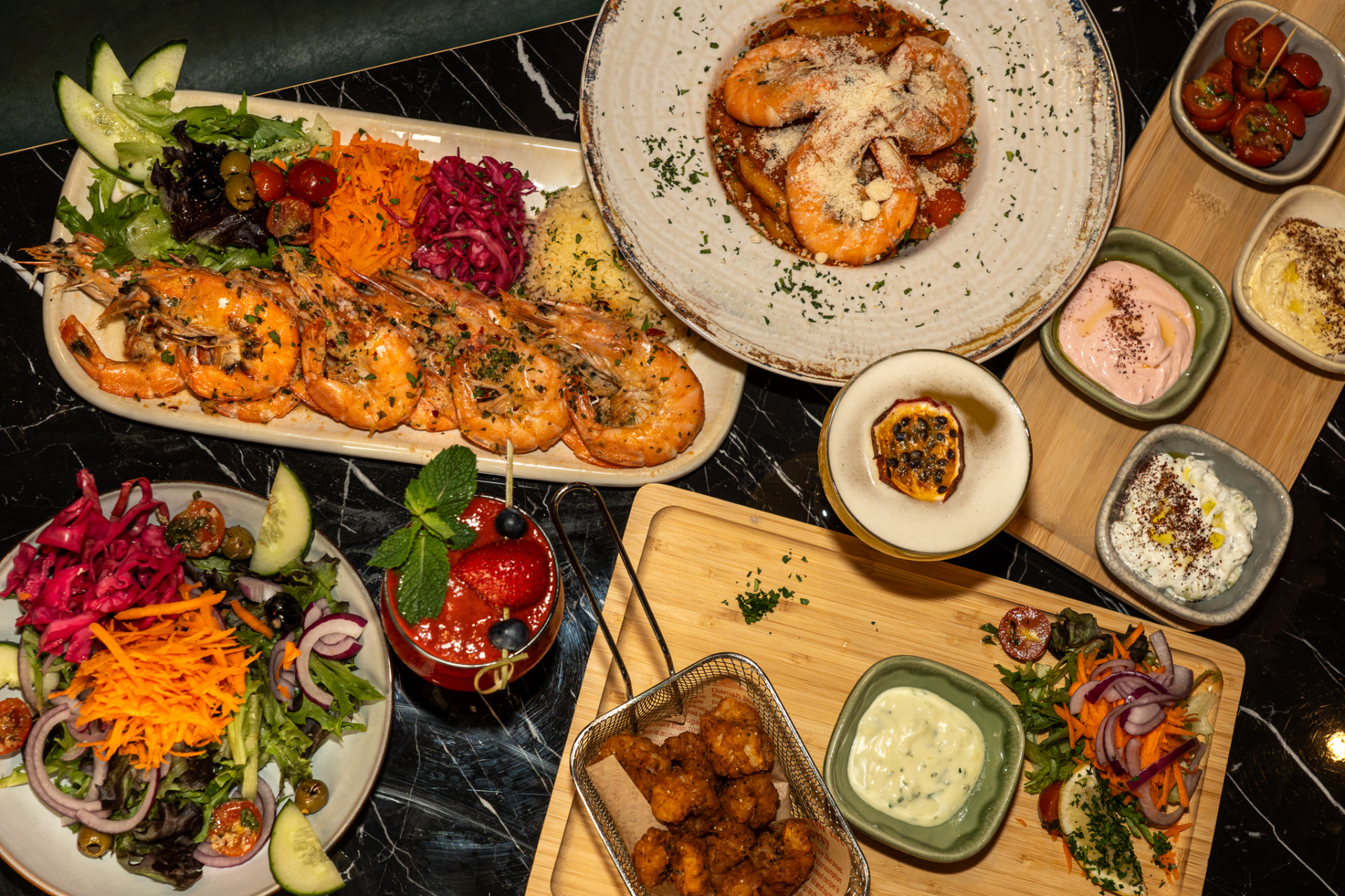 A spread of grilled prawns, seafood and colourful sides at Nova